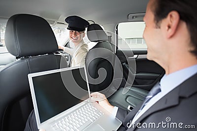 Businesswoman being chauffeured while working Stock Photo