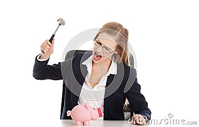 Businesswoman breaking a piggybank Stock Photo