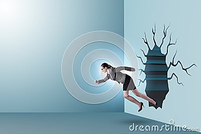 Businesswoman breaking through the wall Stock Photo