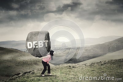 Businesswoman brings rock with Debt word Stock Photo