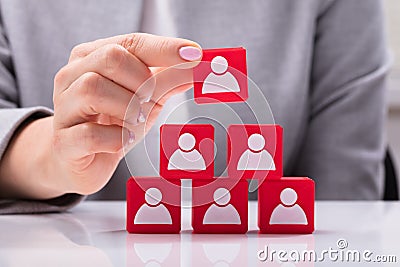 Businesswoman Building Blocks Of A Team Stock Photo