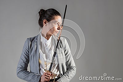 A businesswoman in a business casual suit attacks competitors, Stock Photo