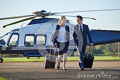 Businesswoman And Businessman In Discussion As They Walk Away Fr Stock Photo
