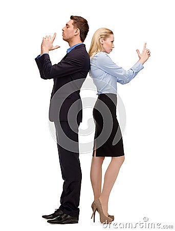 Businesswoman and businessman with imaginary guns Stock Photo