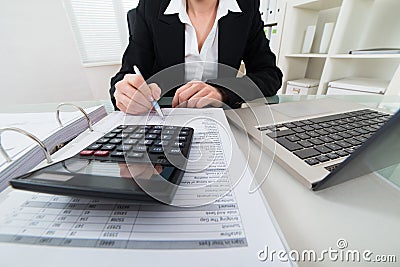 Businesswoman Calculating Invoice Stock Photo