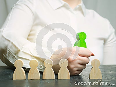 Businesswoman choose a person from the crowd. Team management. Employee selection. Human resources. Talented worker. Choose a new Stock Photo