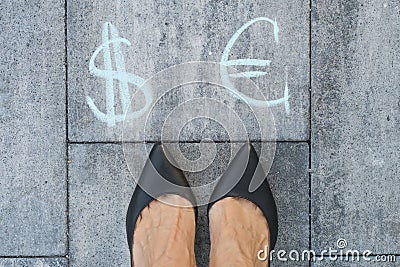 Businesswoman chooses euro or dollar signs. Stock Photo