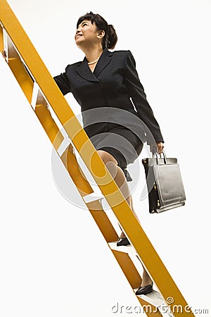 Businesswoman climbing ladder. Stock Photo