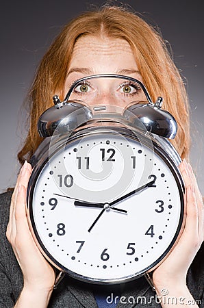 Businesswoman with clock being late Stock Photo