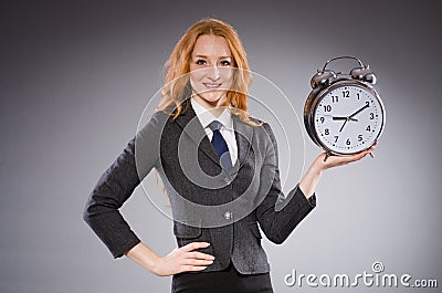 Businesswoman with clock being late Stock Photo