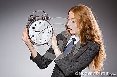 Businesswoman with clock being late Stock Photo
