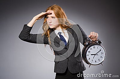 Businesswoman with clock being late Stock Photo