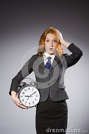 Businesswoman with clock being late Stock Photo