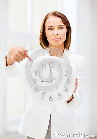 Businesswoman with clock Stock Photo