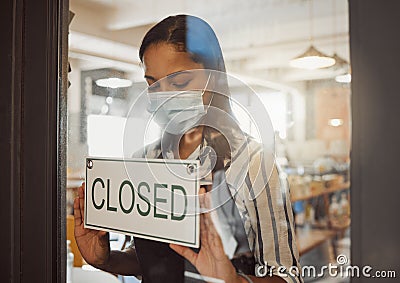Businesswoman closing her shop in the pandemic. Business owner hanging a closing sign in her shop entrance. Small Stock Photo
