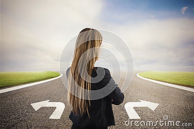 Businesswoman at a crossroads. She chooses the correct way. Concept of decision in business Stock Photo