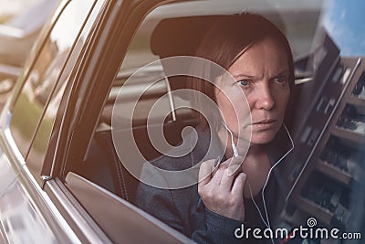 Businesswoman dictating into smartphone earphones microphone Stock Photo