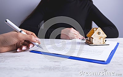 Businesswoman documents house Stock Photo