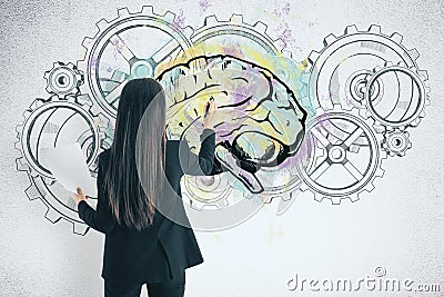 Businesswoman drawing cogs and brain sketch Stock Photo