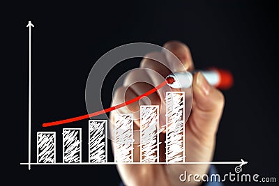 Businesswoman drawing rising graph Stock Photo