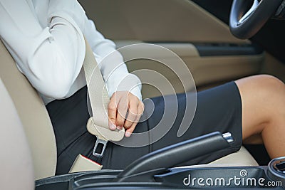 Businesswoman fastening seat belt in car before driving Stock Photo