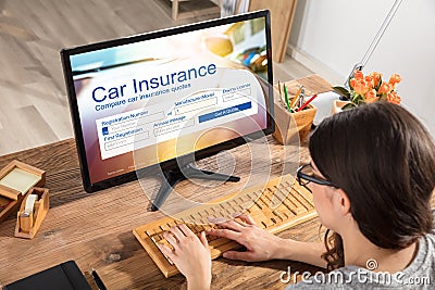 Woman Filling The Car Insurance Form On Computer Stock Photo
