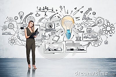 Businesswoman in green dress t is standing near colourful sketch Stock Photo