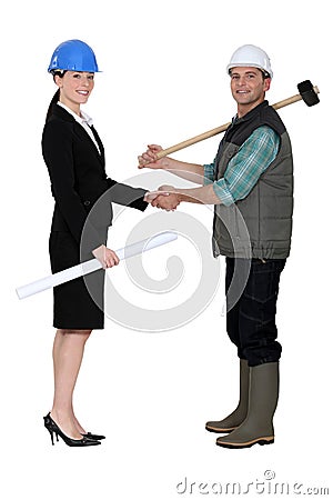 Businesswoman greetin manual worker Stock Photo