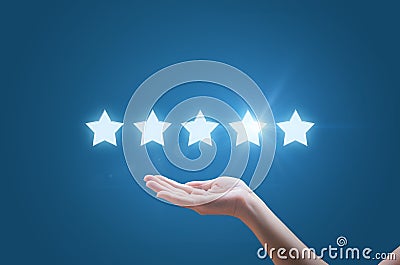 Businesswoman hand holding five stars isolated Stock Photo