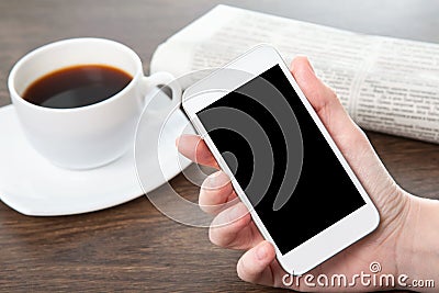 Businesswoman hand holding a phone in the office Stock Photo