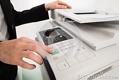 Businesswoman Hand Pressing Printer's Button Stock Photo