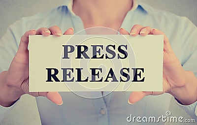 Businesswoman hands holding card sign with press release message Stock Photo