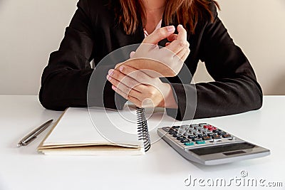 Businesswoman hands pain on desk office syndrome with notebook a Stock Photo