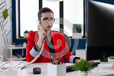 Businesswoman having a phone coversation with financial adviser Stock Photo