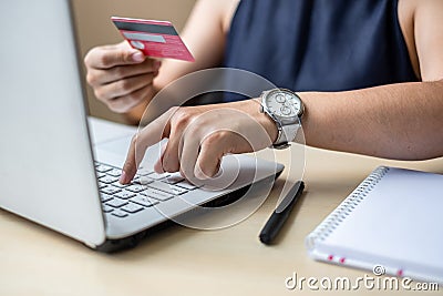 Businesswoman holding credit card for online shopping while making orders via the Internet. business, technology, ecommerce and Stock Photo