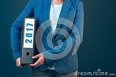 Businesswoman holding 2017 document binder with archived files Stock Photo