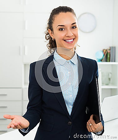 Businesswoman holding documents in hands in office Stock Photo