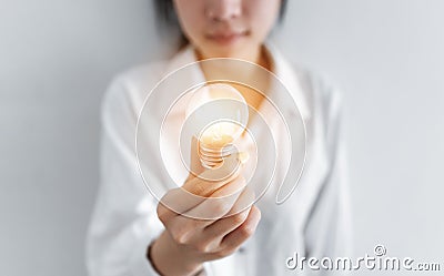 Businesswoman holding glowing light bulb, on white background Stock Photo