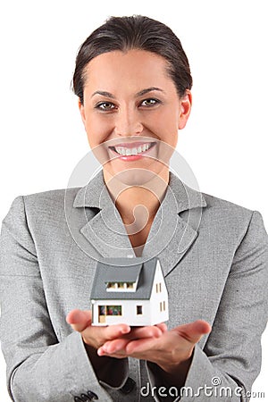 Businesswoman holding home Stock Photo