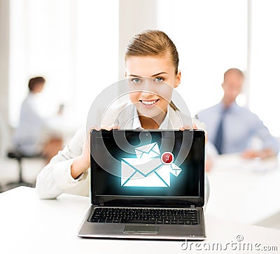 Businesswoman holding laptop with email sign Stock Photo