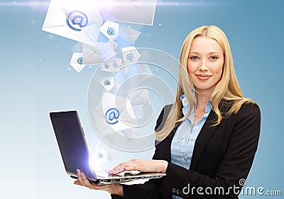 Businesswoman holding laptop with email sign Stock Photo