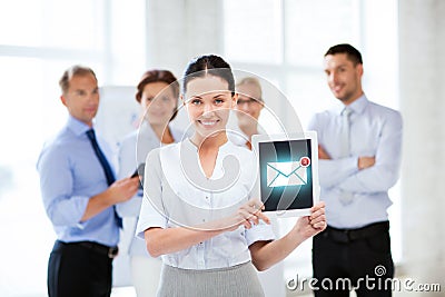 Businesswoman holding tablet pc with email sign Stock Photo