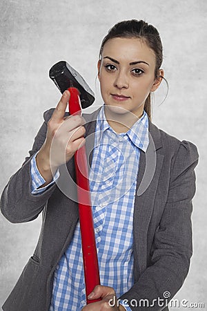 Businesswoman holds a big hammer Stock Photo
