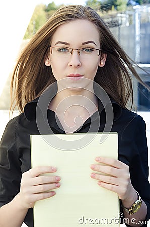Businesswoman holds a yellow folder with paper Stock Photo