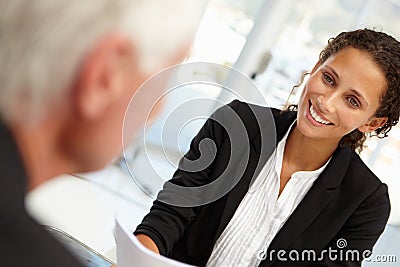 Businesswoman interviewing male employee Stock Photo