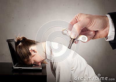 Businesswoman with a key winder on her back Stock Photo