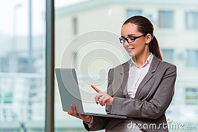 The businesswoman with laptop in business concept Stock Photo