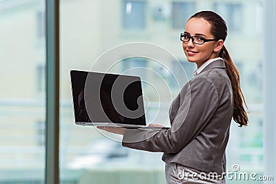 The businesswoman with laptop in business concept Stock Photo