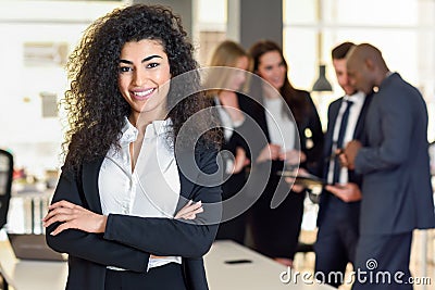 Businesswoman leader in modern office with businesspeople working at background Stock Photo