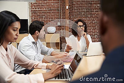 Businesswoman Leading Office Meeting Of Colleagues Sitting Around Table Stock Photo
